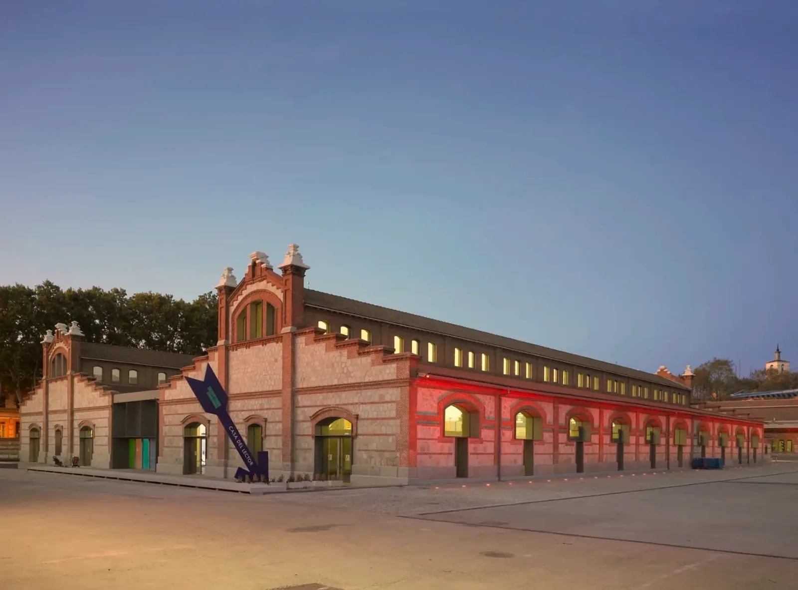 The brick and stone halls of Matadero Madrid at dusk